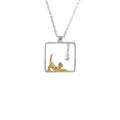 Necklace with a square pendant featuring a gold cat and silver bell